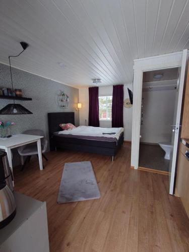 a room with a bed and a table in a room at Jävregården in Jävre
