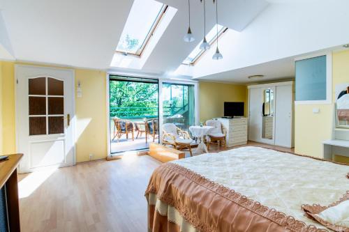a bedroom with a large bed and a living room at Willa Sarenka in Radzyń