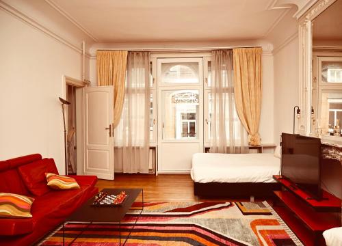 a living room with a bed and a couch at Viktoria B & B in Brussels