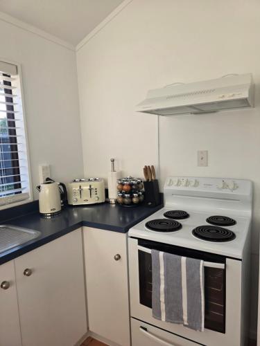 a kitchen with a white stove and a counter top at Changing Seasons in Cambridge