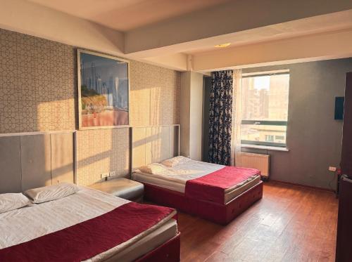 a hotel room with two beds and a window at Twin Horse Hotel in Ulaanbaatar