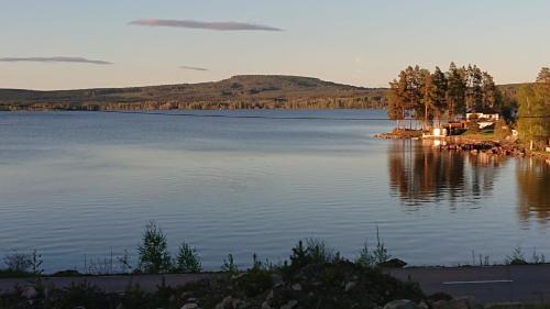 a view of a large lake with a house on the shore at Lake View Villa in Falun