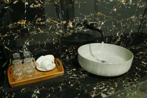 a bathroom with a sink and a bowl on a counter at Danu Homestay Kandy in Kandy