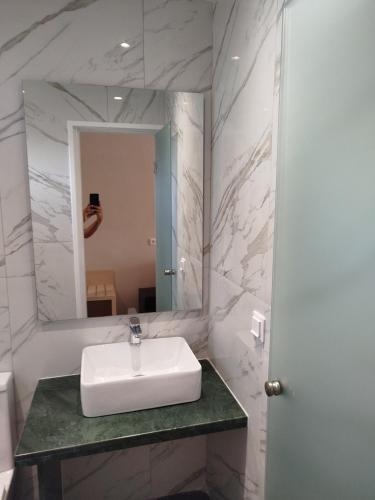 a bathroom with a sink and a mirror at Frosini Gardens in Kassiopi