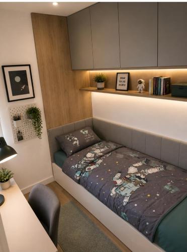 a bedroom with a bed and a desk in it at Euforia Ma Apartment Sarajevo in Sarajevo