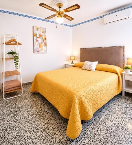 a bedroom with a bed and a ceiling fan at CASA EN EL CENTRO HISTORICO in Nerja