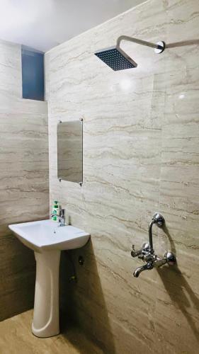 a bathroom with a sink and a mirror at Hotel Neelkanth in Lucknow