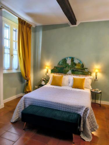 a bedroom with a large bed with yellow pillows at Il Sonetto Boutique Apartment - private garage in Mantova