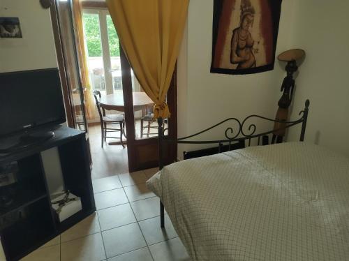 a bedroom with a bed and a television and a table at Fab's Home in Oust