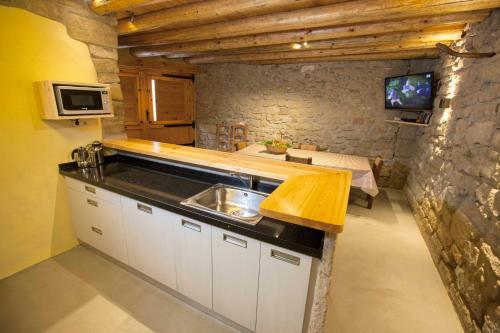 a kitchen with a sink and a counter top at Solano de Moran in Murillo de Gállego
