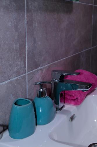 a bathroom sink with a blue mug and a faucet at La Casa Di Martin in Ulcinj