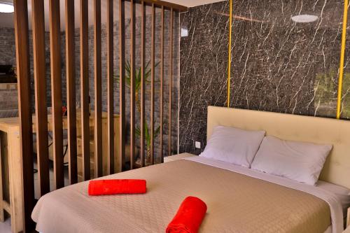 a bedroom with a bed with red pillows on it at La Casa Di Martin in Ulcinj