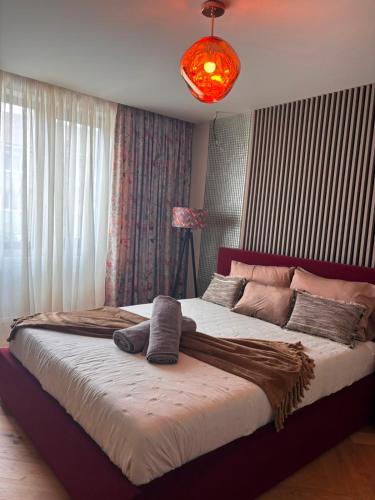 a bedroom with a large bed with a blanket on it at GZP Residence Lugoj 13 in Lugoj