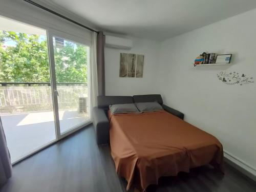 a bedroom with a bed and a large window at Lorena in Salou