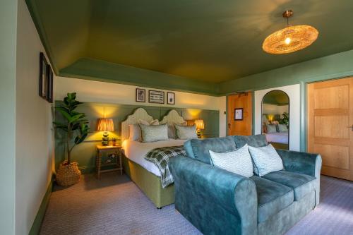 a living room with a couch and a bed at The Mayflower in Lymington