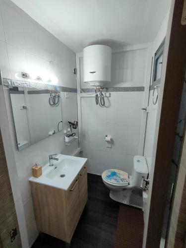 a white bathroom with a sink and a toilet at Lorena in Salou
