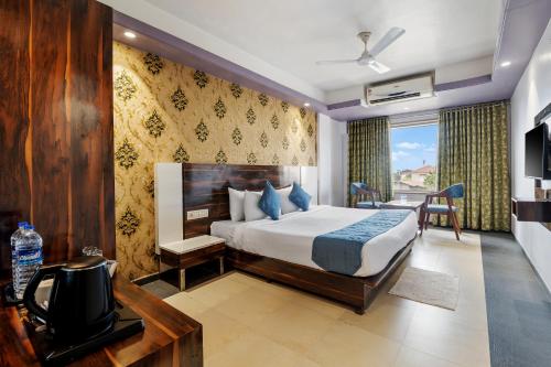 a bedroom with a bed and a television in a room at Mountview Resort in Lonavala