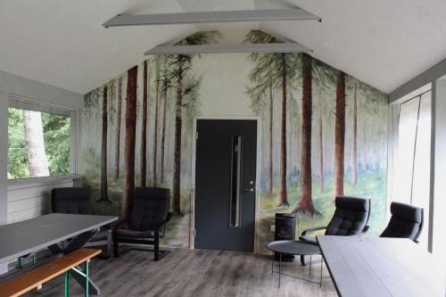 a room with a painting of trees on the wall at Lubānas mototrase in Lubāna