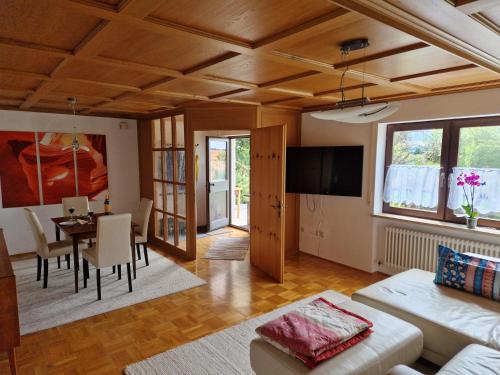 a living room with a table and a dining room at Ferienwohung Lederle in Weiler-Simmerberg