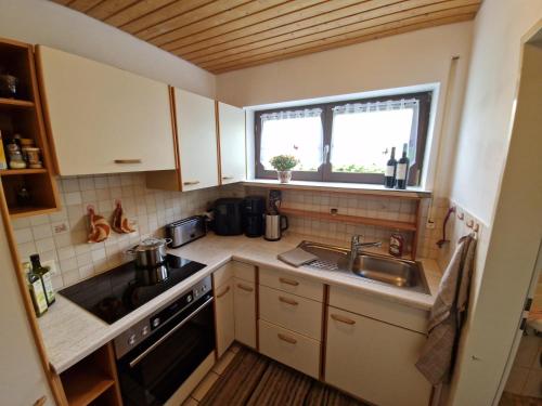 a small kitchen with a sink and a window at Ferienwohung Lederle in Weiler-Simmerberg