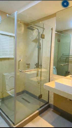a glass shower in a bathroom with a toilet at CARITAS HOTEL AND suite in Araromi