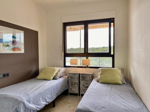 a bedroom with two beds and a window at Luxurious apartment seafront Moraira by Moraira Holiday Homes in Moraira
