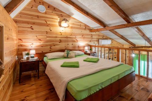 a bedroom with a large bed in a wooden cabin at Bamboo River House in Ulcinj