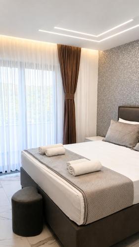 a bedroom with a large bed with two towels on it at Horizon Crown Rooms Ulcinj in Briska Gora