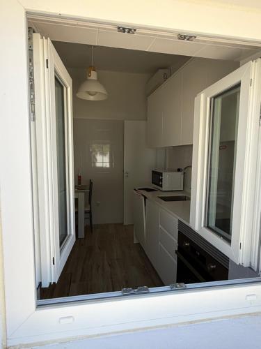 a kitchen with white cabinets and a counter top at Casa do Pátio in Mértola