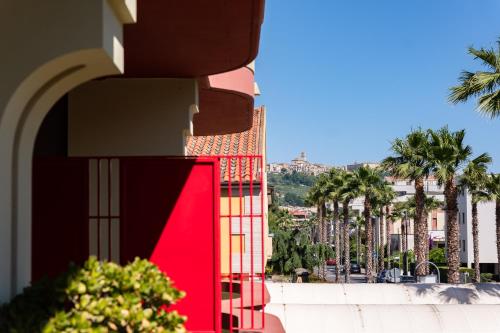 a view of a building with palm trees in the background at Hotel Twins in Vasto