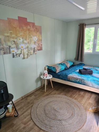 a bedroom with a bed and a rug at Purple Diamond in Damiş