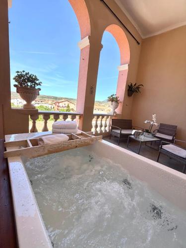 a jacuzzi tub in a house with a view at Palazzo Pischedda in Bosa