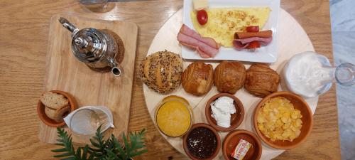 a table with a plate of food with breakfast foods at Suite Loc Suite & Spa in Casablanca