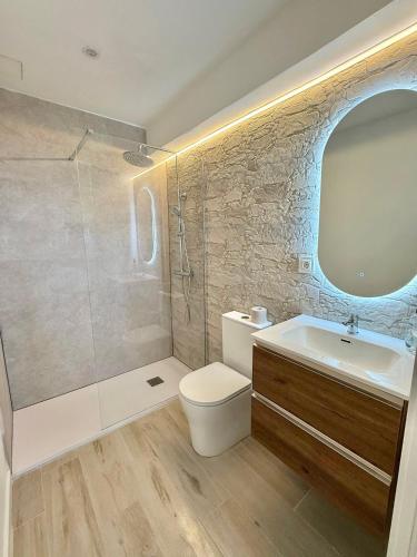 a bathroom with a toilet and a sink and a shower at Cala Crancs - Sea Views in Salou