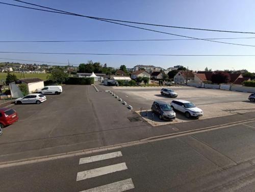 a parking lot with several cars parked in it at Le bouf tard chambre vue sur jardin CH7 in Vendôme