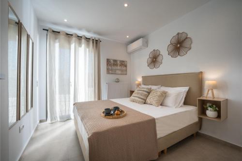 a bedroom with a bed with a tray of food on it at Kaerati Athens in Vari