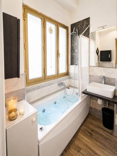 a bathroom with a tub and a sink at L'angolo del Viaggiatore 5 Terre in La Spezia
