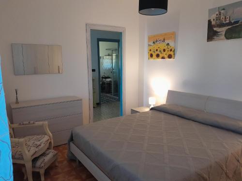 a bedroom with a bed and a table and a chair at Casa Cristina in Ospedaletto Euganeo
