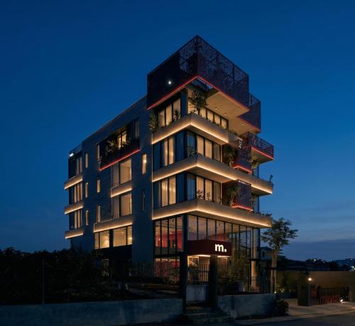 a tall building at night with its lights on at Mevan Hotel Dalat in Da Lat