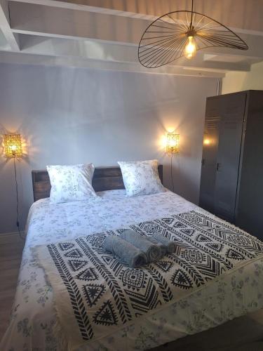 a bedroom with a large bed with white sheets and pillows at Calme et quiétude in Saint-Vivien-de-Blaye