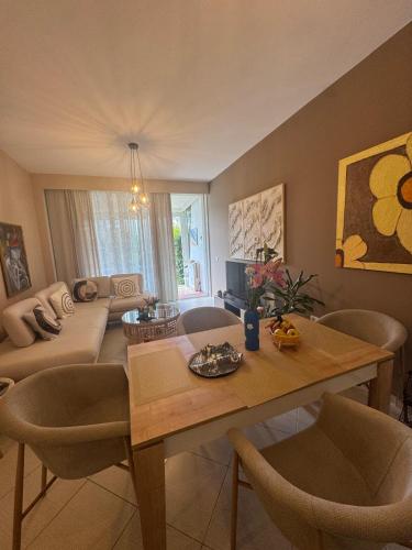 a living room with a table and a couch at Blue Paradise - Gjiri i Lalezit in Lalzit Bay