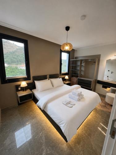 a bedroom with a large bed with two towels on it at Mirşah Suit in Dalaman