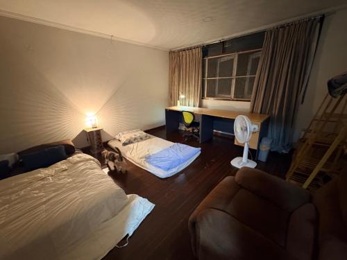 a hotel room with a bed and a couch at Southeast Asia Activist House in Bangkok