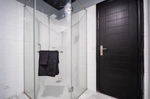 a shower with a glass door and a towel at Modern executive stay in Lahore Long stay ready in Lahore