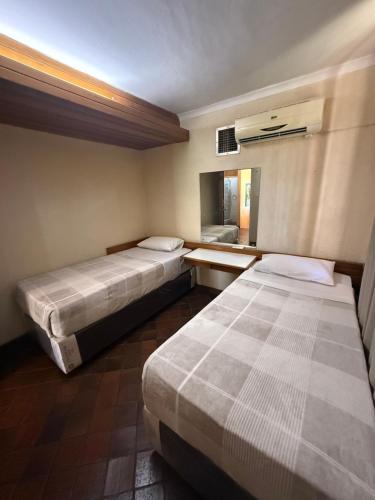 a hotel room with two beds and a window at Sunrise and sunsets lodge previously known as leopard lodge in Kariba