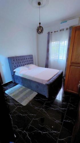 ein Schlafzimmer mit einem Bett in einem Zimmer in der Unterkunft Palace M&E in Douala