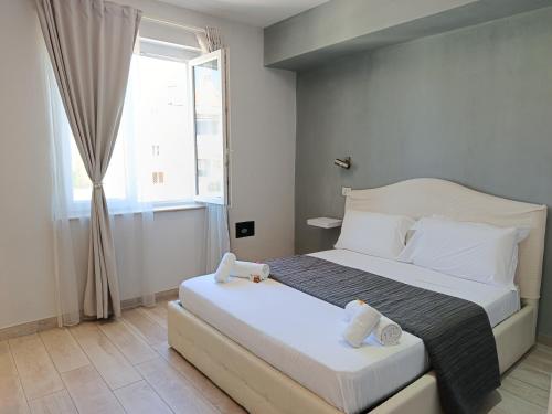 a bedroom with a large bed and a window at B&B Purple Italy in Fiumicino