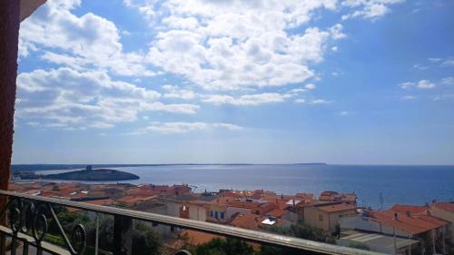 a view of a city and the ocean from a balcony at Hotel Bellavista S'Archittu in S'archittu Cuglieri