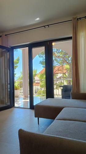 a bedroom with two beds and a view of a patio at 5 srca in Stanići