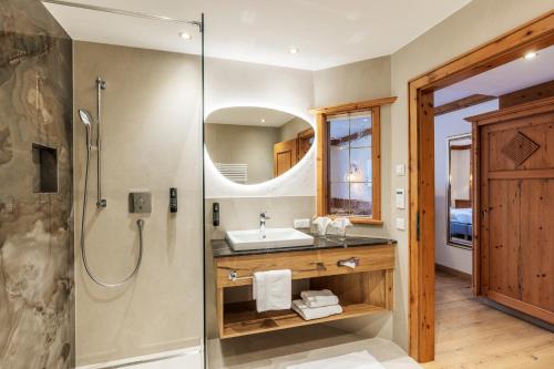 a bathroom with a sink and a shower at Landhaus Grünau in Wals